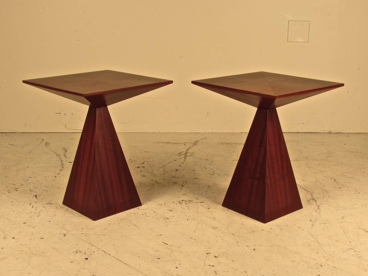 Pair of stunning hyper-rare side tables from the Harvey Probber Studio. These are made of bookmatched ribbon mahogany that literally glimmers from certain vantage points. Fully restored and in exceptional condition.
