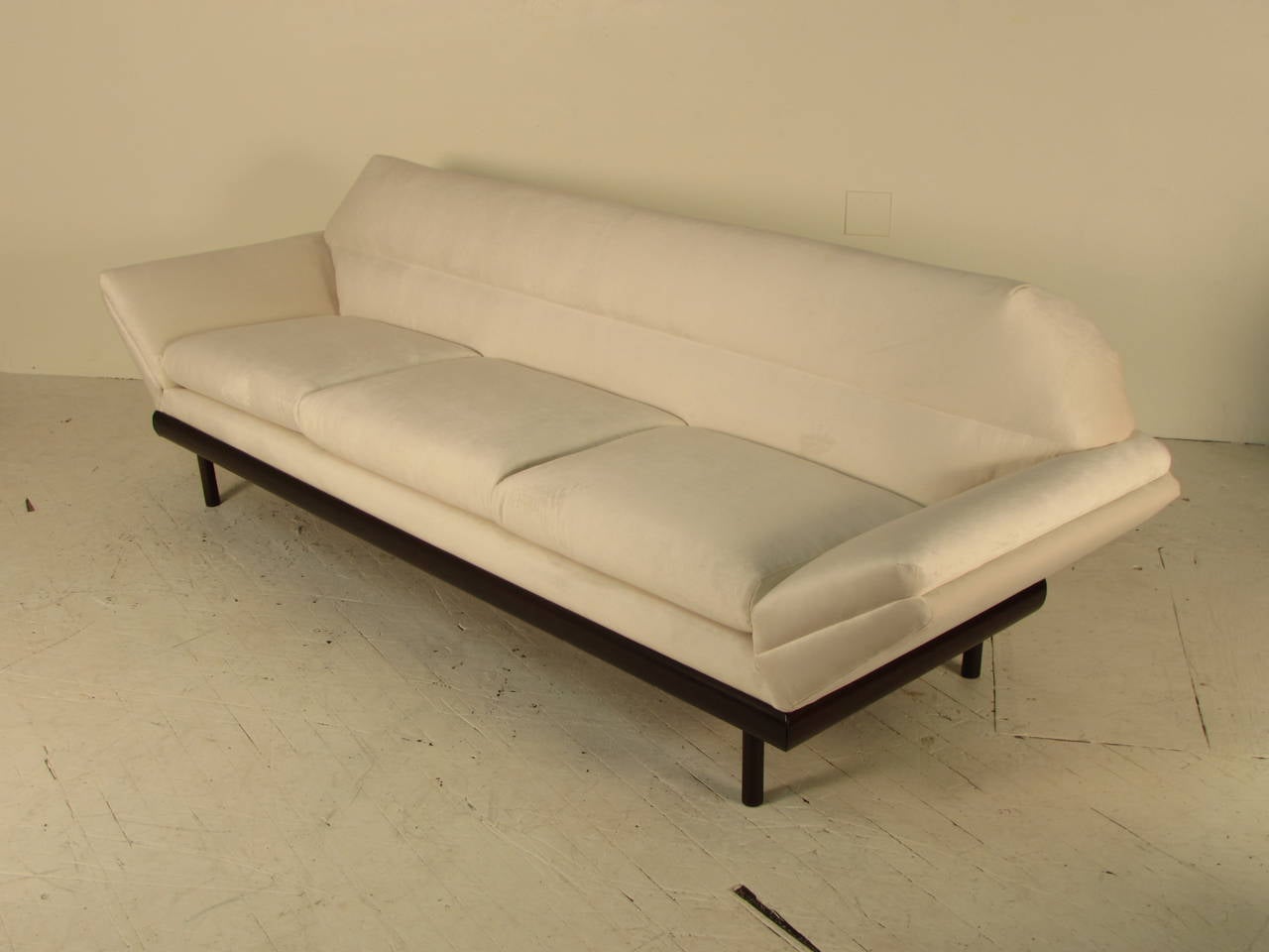 Absolutely fabulous Mid-Century Modern sofa in the style of Adrian Pearsall, but with sleek, Italian leanings. Dark walnut base has been fully restored and the sofa has just been reupholstered in an off-white velvet.