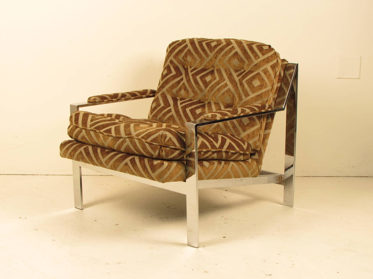 Wonderfully sculptural lounge chair designed by Cy Mann and often attributed to Milo Baughman. Heavy flat bar chrome construction and incredible lines from all angles! Reupholstered in contemporary, period appropriate velvet with a geometric relief