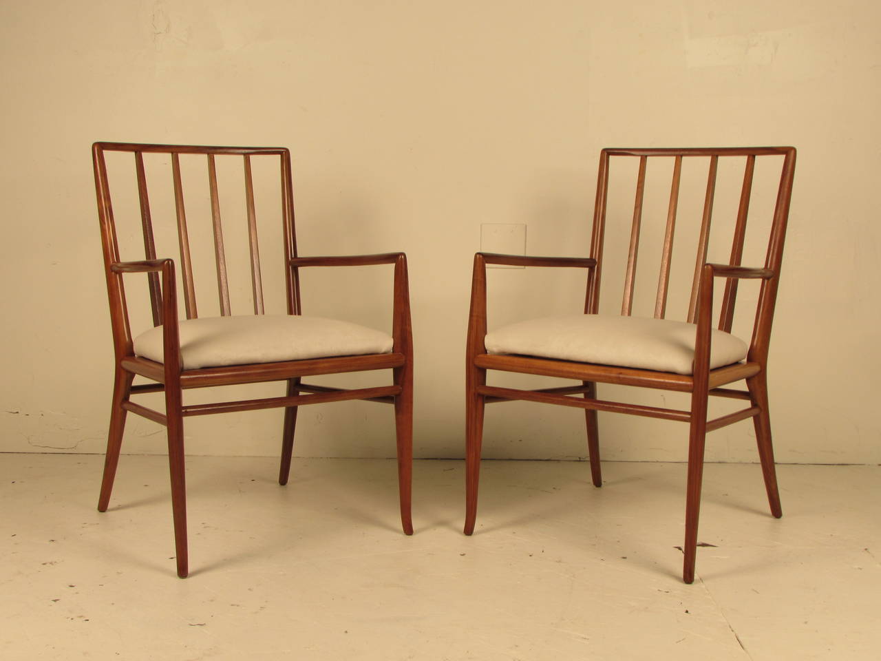 Sculptural armchairs by T.H. Robsjohn-Gibbings. These chairs can be used as occasional chairs or coupled with the matching side chairs as a dining set. They have been fully restored and are in glowing condition.
