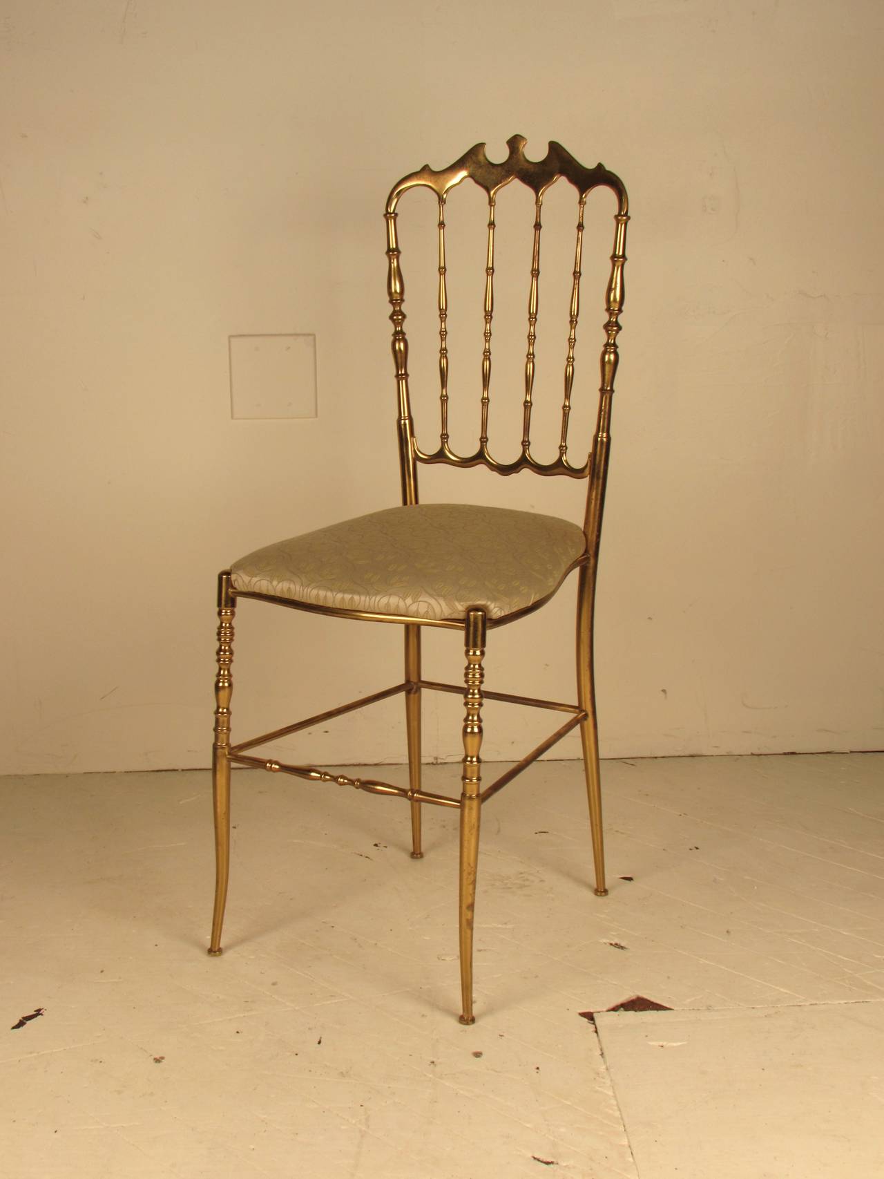 Brass chair designed by Giuseppe Gaetano Descalzi and handmade in Italy by Chiavari. Graceful, elegant lines would make this a lovely candidate to accompany a special vanity or desk. 
Brass is in overall very good condition and shows beautifully.