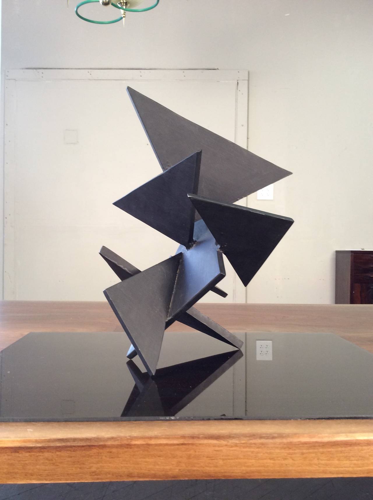 Geometric constructivist sculpture composed of thick steel triangles, signed 
