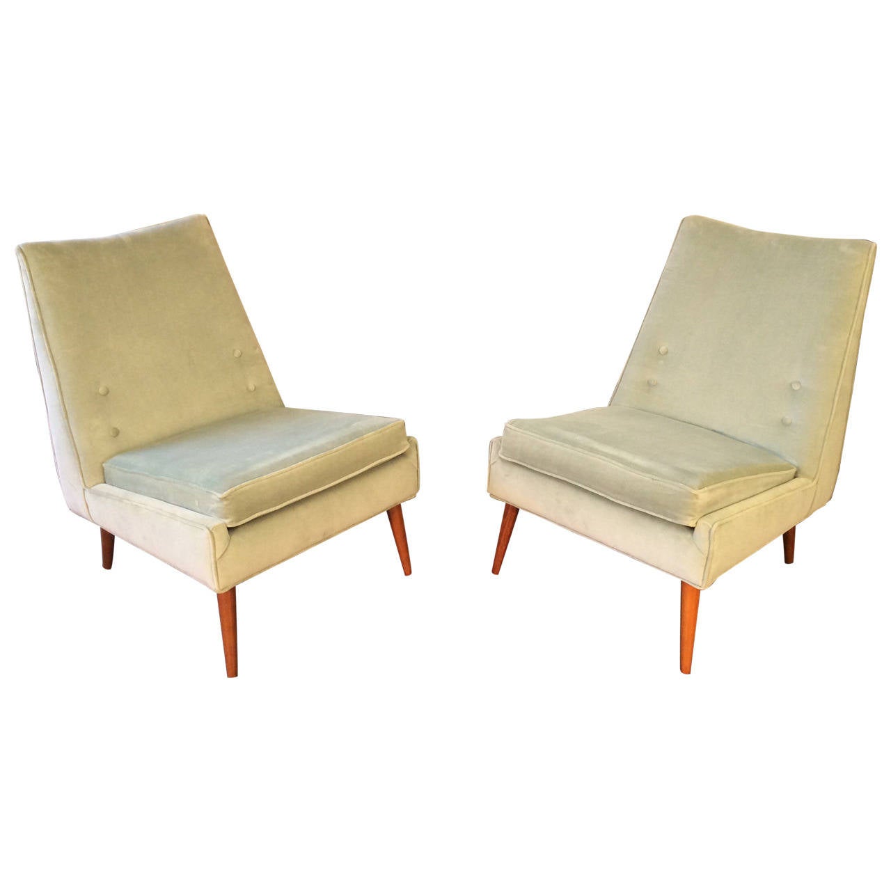 Impeccable early 1950s slipper lounge chairs in the style of Paul McCobb for Winchendon. The upholstery is a beautiful sea foam velvet. Legs are a light walnut. 

We provide weekly complimentary delivery to NYC and surrounding areas.