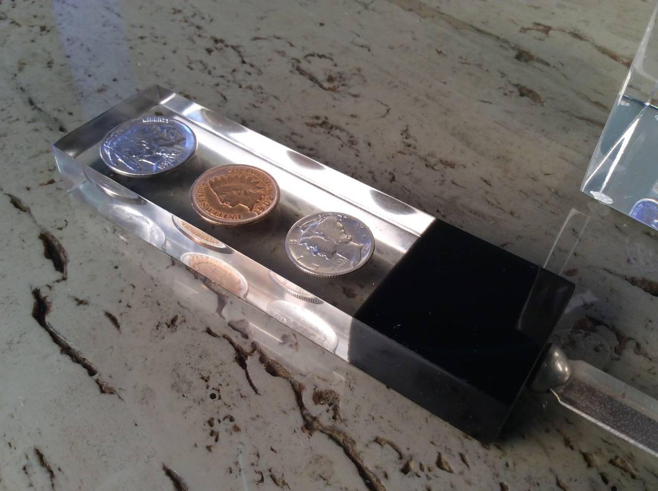 Nothing better than Lucite and money! Lucite letter opener and paperweight set with suspended US and Canadian Coin, 1970s. Beautiful desk accessories in excellent condition. 

In the style of Charles Hollis Jones, etc.