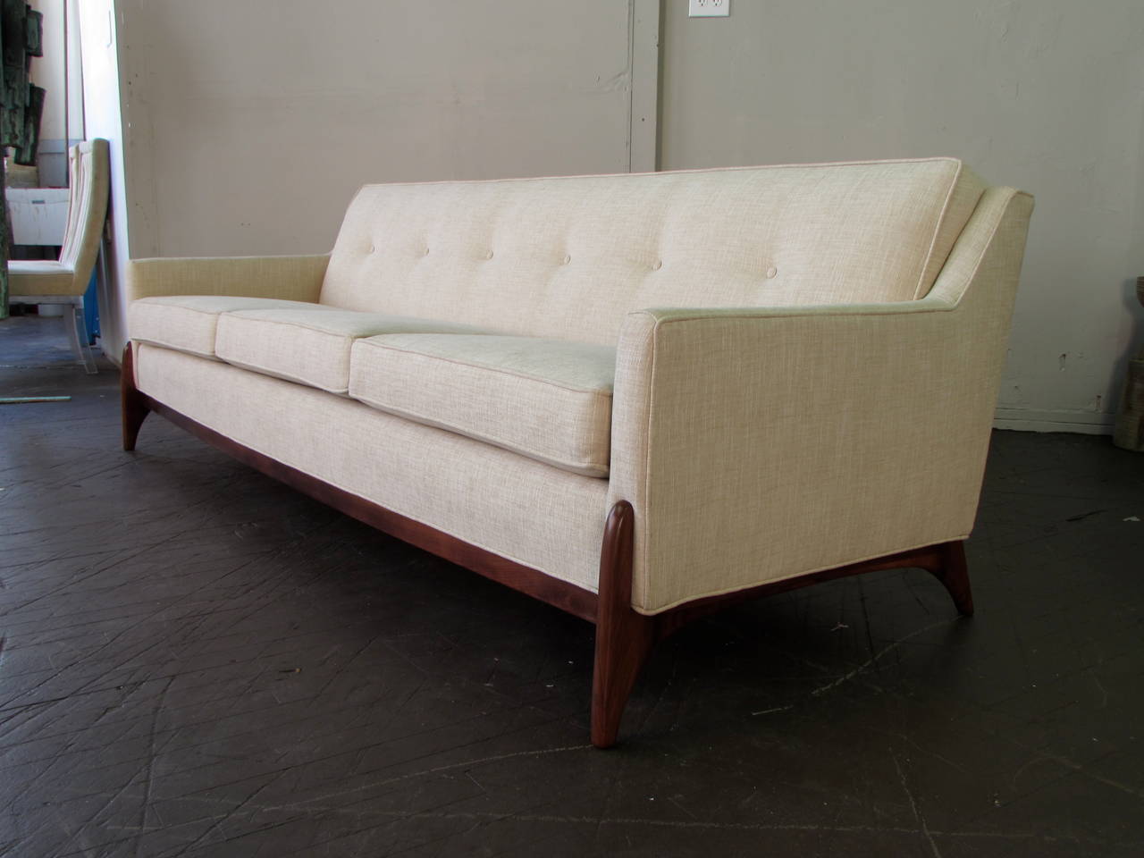 Stunning Mid-Century Modern Sofa with Sculptural Legs, circa 1950. This piece is a favorite of ours. Maker is unknown but the design is exceptional and the quality is superb. Newly upholstered in a textured oatmeal fabric that is of the period.