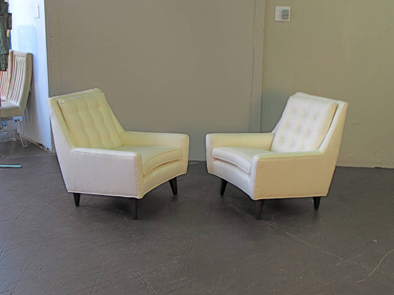 Classic Mid-Century Modern lounge chairs, circa 1950. These chairs are both sculptural and comfortable. Seat fronts and head rest have a beautiful curved detail. The clean, simple lines allow these chairs to work in any room. Upholstery is new.