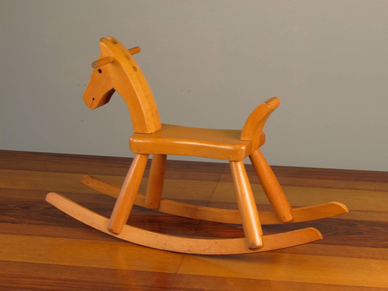 Fantastic and rare child's rocking horse by Kay Bojesen, Denmark, circa 1940. Carved from beechwood. This piece is in excellent vintage condition with minimal wear for age. The rounded legs are characteristic of an early version of this rocking