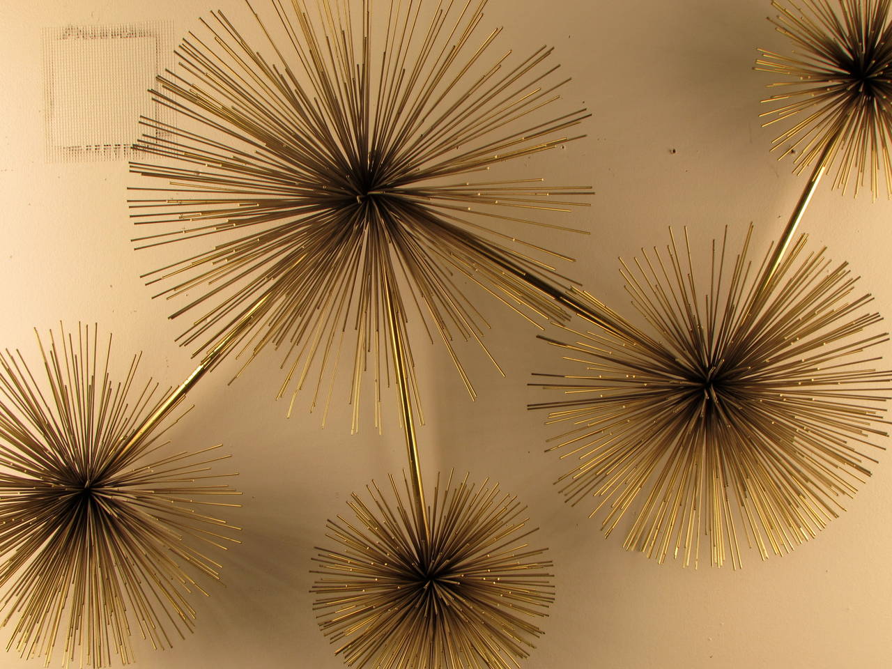 We are pleased to offer this large brass pom pom starburst wall sculpture by Curtis Jere, USA, 1979. It is a very large piece that would look great over a buffet or sofa. The condition is excellent with no damage or losses. A remnant of the C. Jere