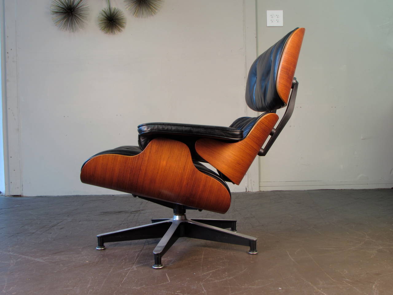 Iconic 670 lounge chair by Charles and Ray Eames for Herman Miller. This chair is in black leather with a lightly grained rosewood veneer. Condition is excellent.

We offer free delivery to NYC and Philadelphia area. Delivery to DC, MD, CT and MA