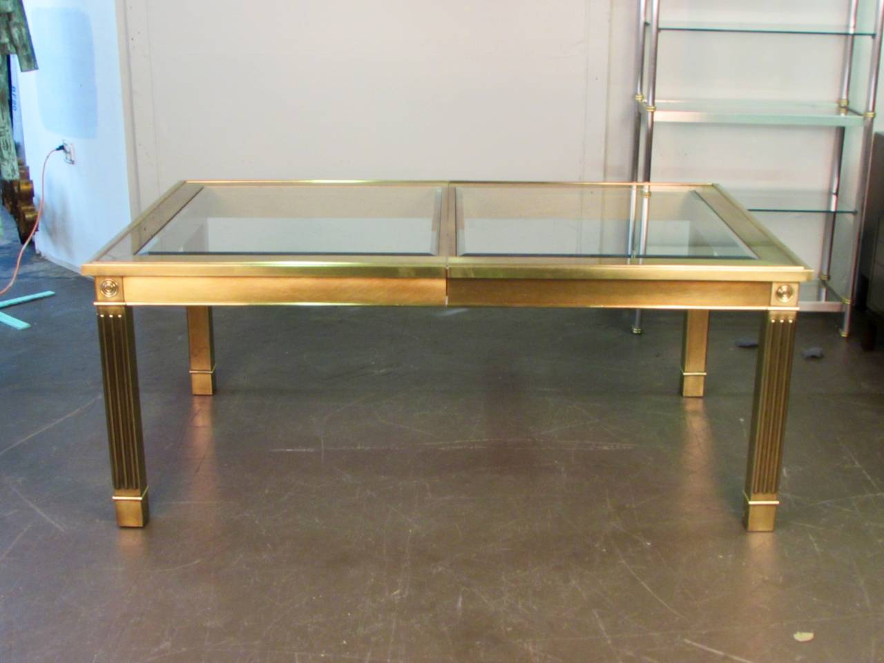 Striking brass and glass dining table with leaf by Mastercraft, 1970s

Dimensions: 74.5