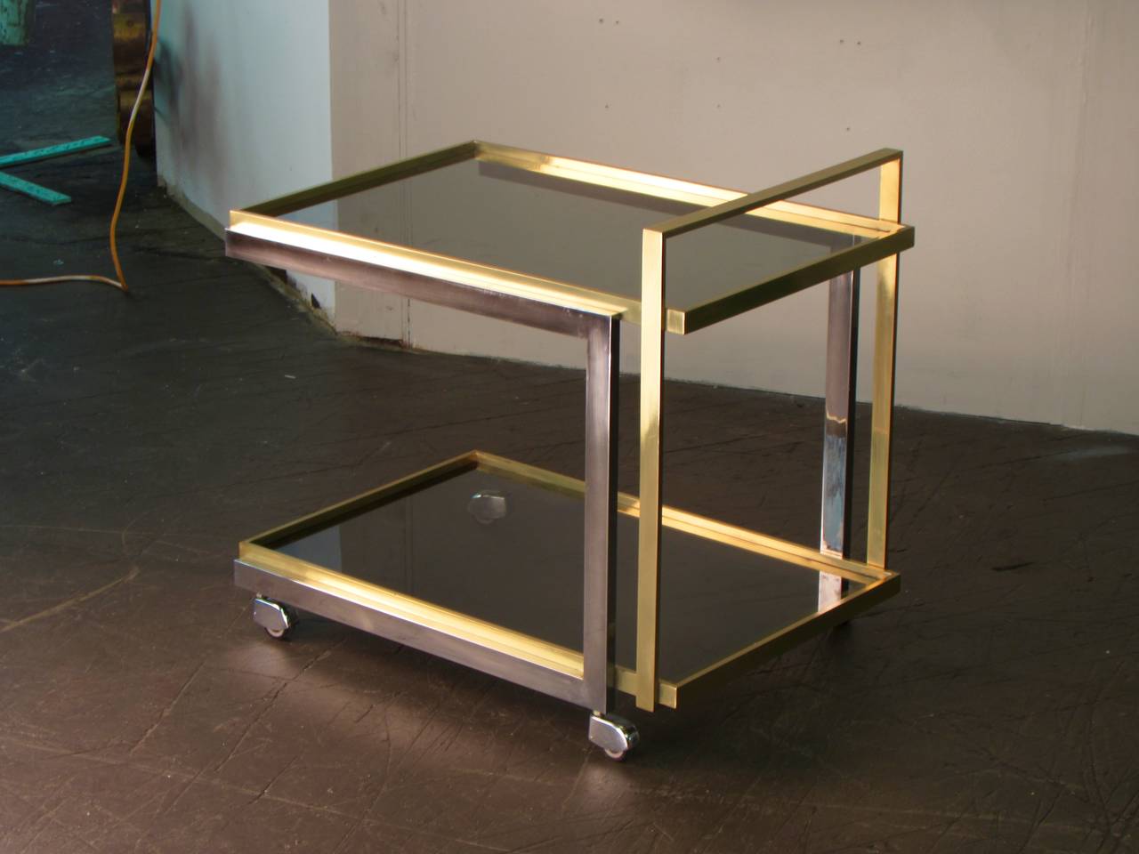Magnificent brass and chrome cantilevered bar cart, Italy 1970s. This is one of the best bar carts we have had. Purchased and imported from Italy. The piece is very heavy and of the highest quality. The condition is normal for age and use. Chrome