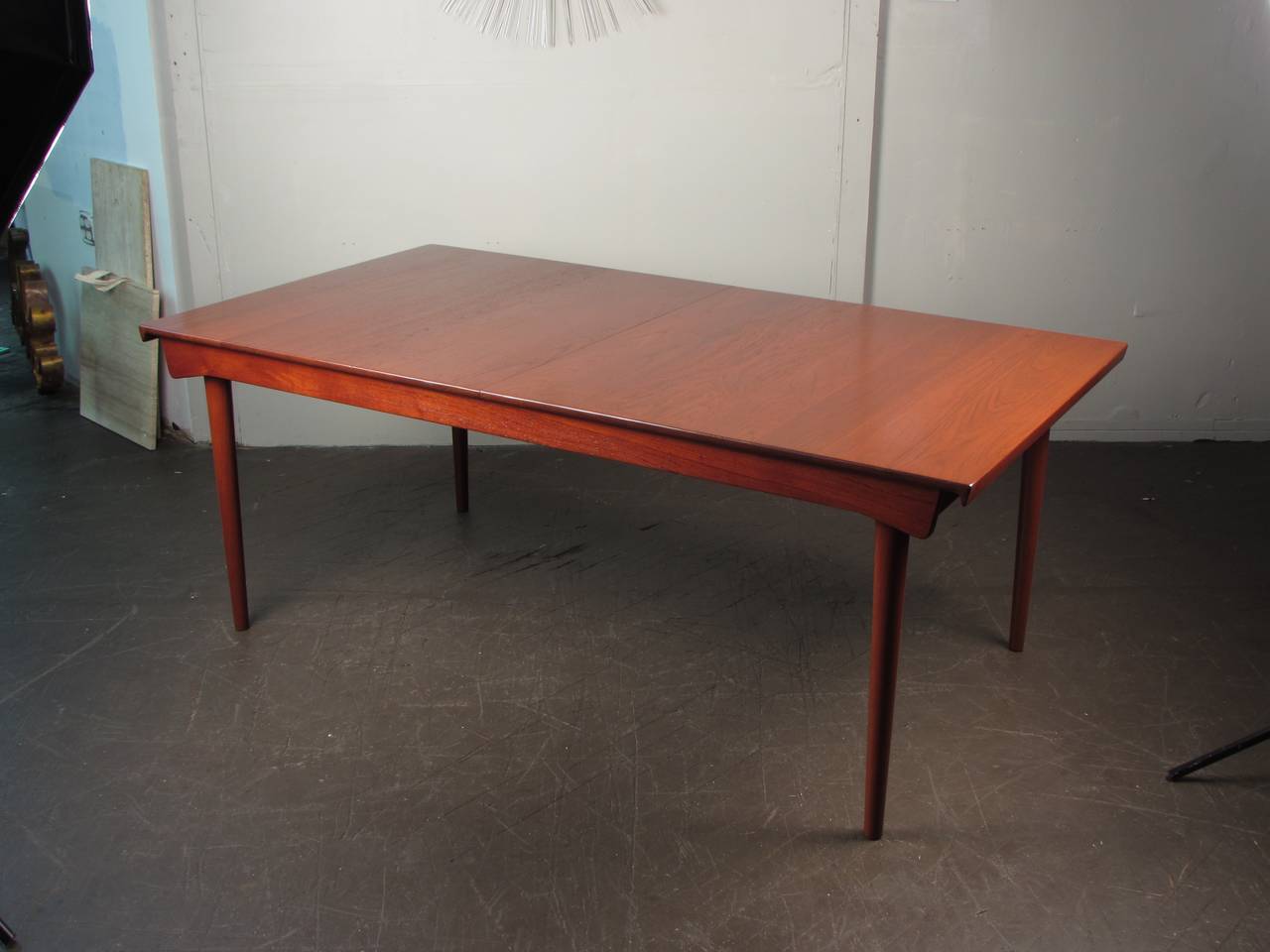 Stunning extendable teak dining table by Finn Juhl, France & Sons model 540. An incredible example of Danish modern furniture. This table has gorgeous wood grain and deep rich teak color. This piece has been fully restored. Two 20