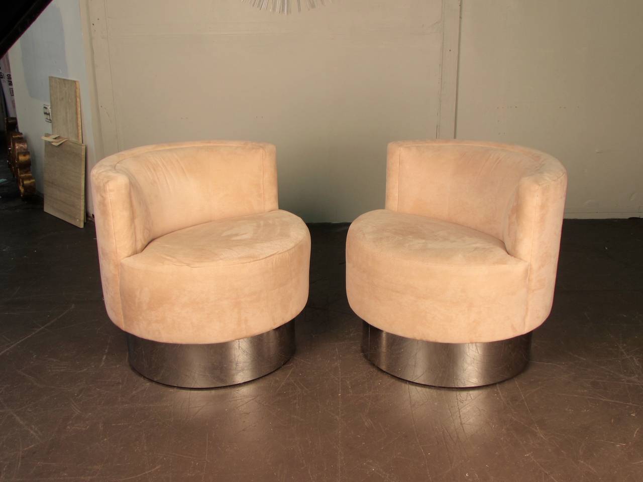 Pair of swivel lounge chairs on smoked chrome bases, five chairs available. These chairs are very well made and heavy. Chrome bases are in excellent condition. Velvet upholstery needs to be redone. Maker is unknown. In the style of Leon Rosen, Milo
