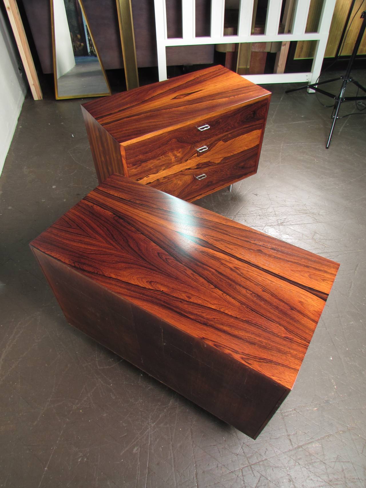 Fantastic pair of rosewood chests or nightstands with aluminum hardware. These cabinets are very versatile because of there size. They can function as a credenza, buffet, dresser, nightstand etc. The wood grain is extraordinary. 

We offer free