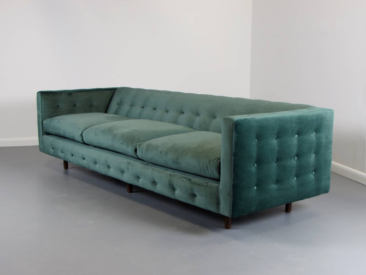 Lavish Velvet Tuxedo Sofa with Button Detail by Harvey Probber, Signed. This sofa is newly refinished in green velvet and very comfortable. Legs are walnut. The seat cushions are spring loaded. Harvey Probber tag in tact. Very heavy, sturdy and of