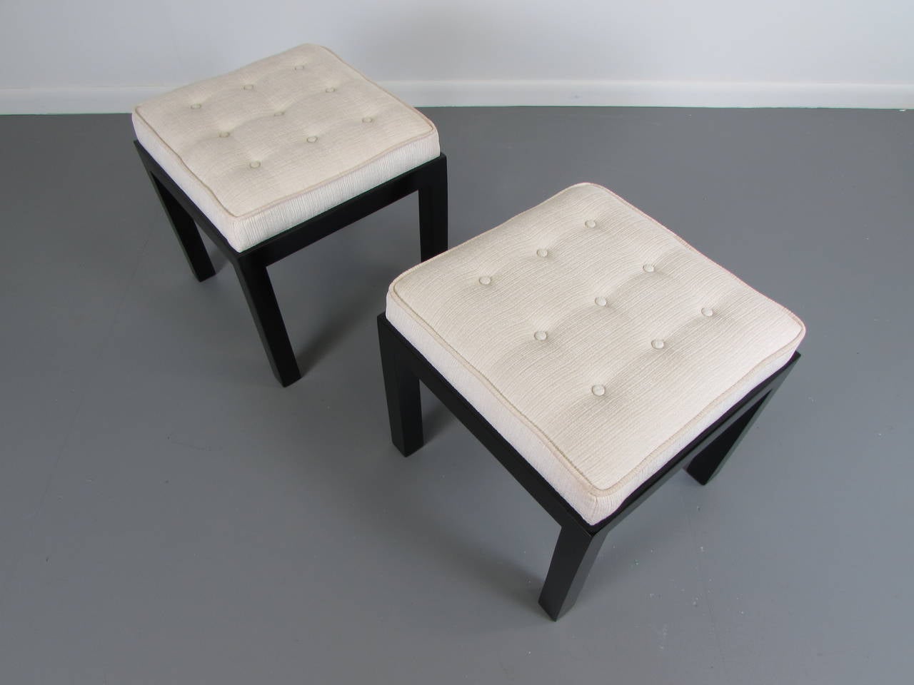 Handsome pair of upholstered stools or benches in the style of Harvey Probber, 1960s. These stools have been refinished and reupholster in a texted cream velvet. Condition is immaculate. 

We offer free regular deliveries to NYC and Philadelphia