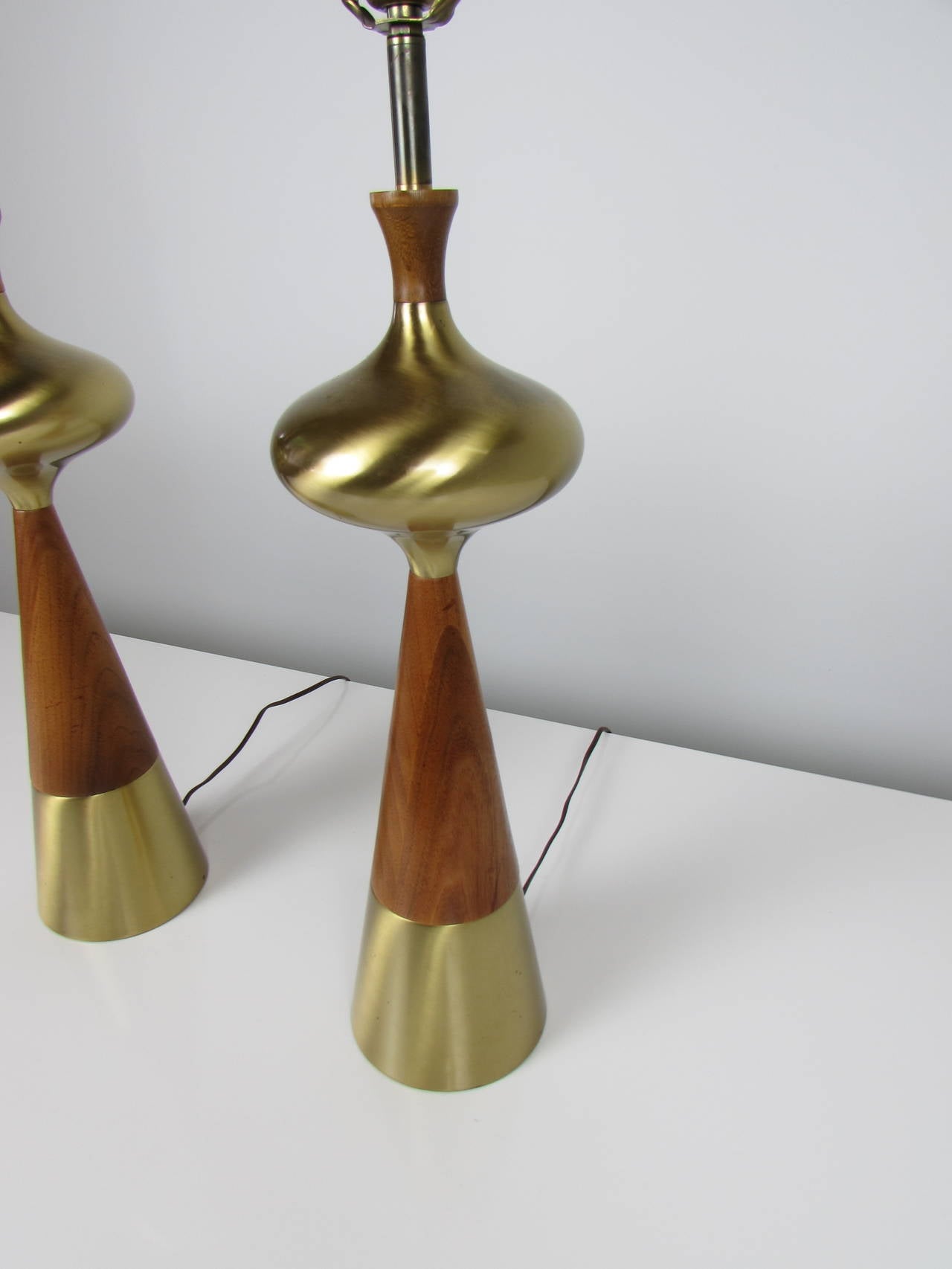Voluptuous table lamps in walnut and brass by Tony Paul for Westwood, 1950s. These lamps are in excellent condition. 

We offer free regular deliveries to NYC and Philadelphia area. Delivery to DC, MD, CT and MA are available if schedule permits,