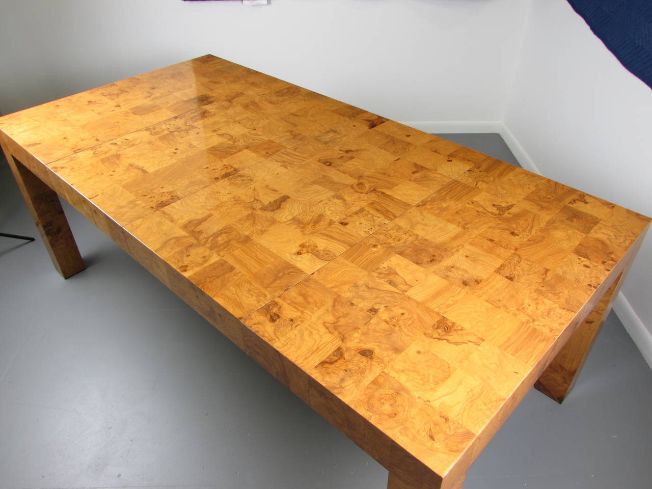 Incredible patchwork checkered burl Parsons dining table by Milo Baughman, 1970s. Pristine vintage condition. Very well made and heavy. Legs are thick and sturdy. 

We offer free regular deliveries to NYC and Philadelphia area. Delivery to DC, MD,