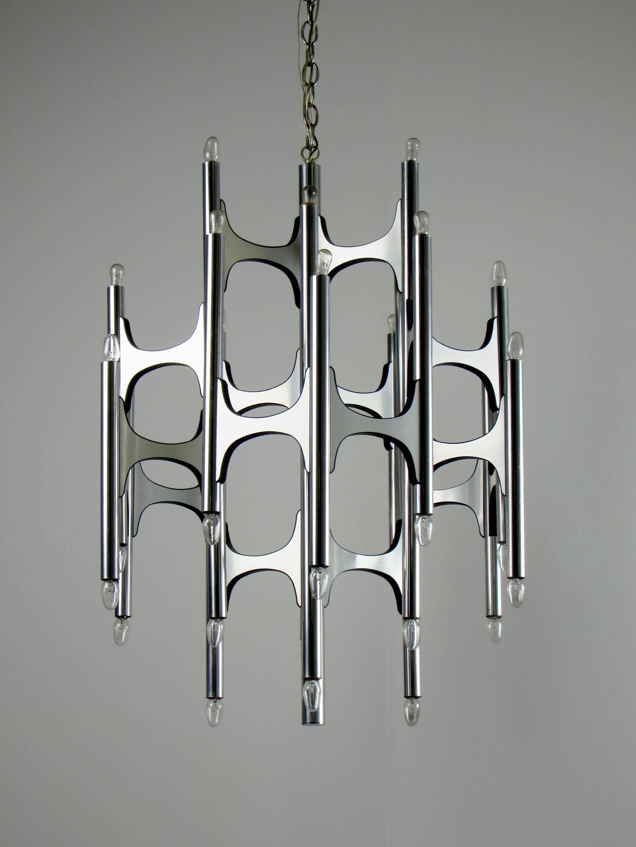 Incredible Brutalist 36 bulb chrome chandelier by Gaetano Sciolari, 1970s. Composed of mirror polished tubes with brushed bowtie-like connectors. Impeccable vintage condition with very little wear.

We offer free regular deliveries to NYC and