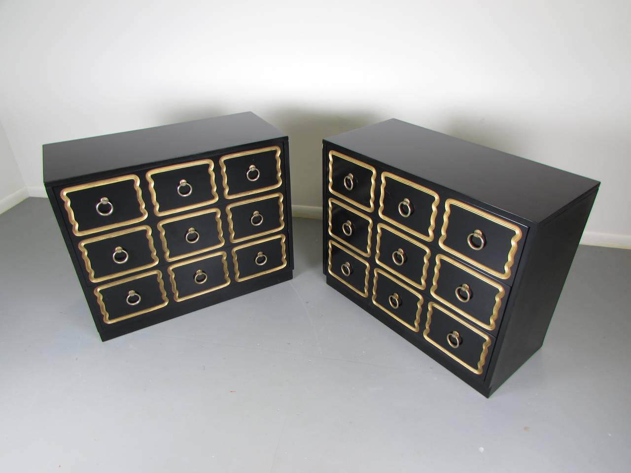 Pair of glamorous Espana chests in black lacquer by Dorothy Draper, 1950s. This pair has been freshly restored in a new black lacquer finish with gold trim. The patinated brass hardware was left in it's original condition. 

We offer free regular