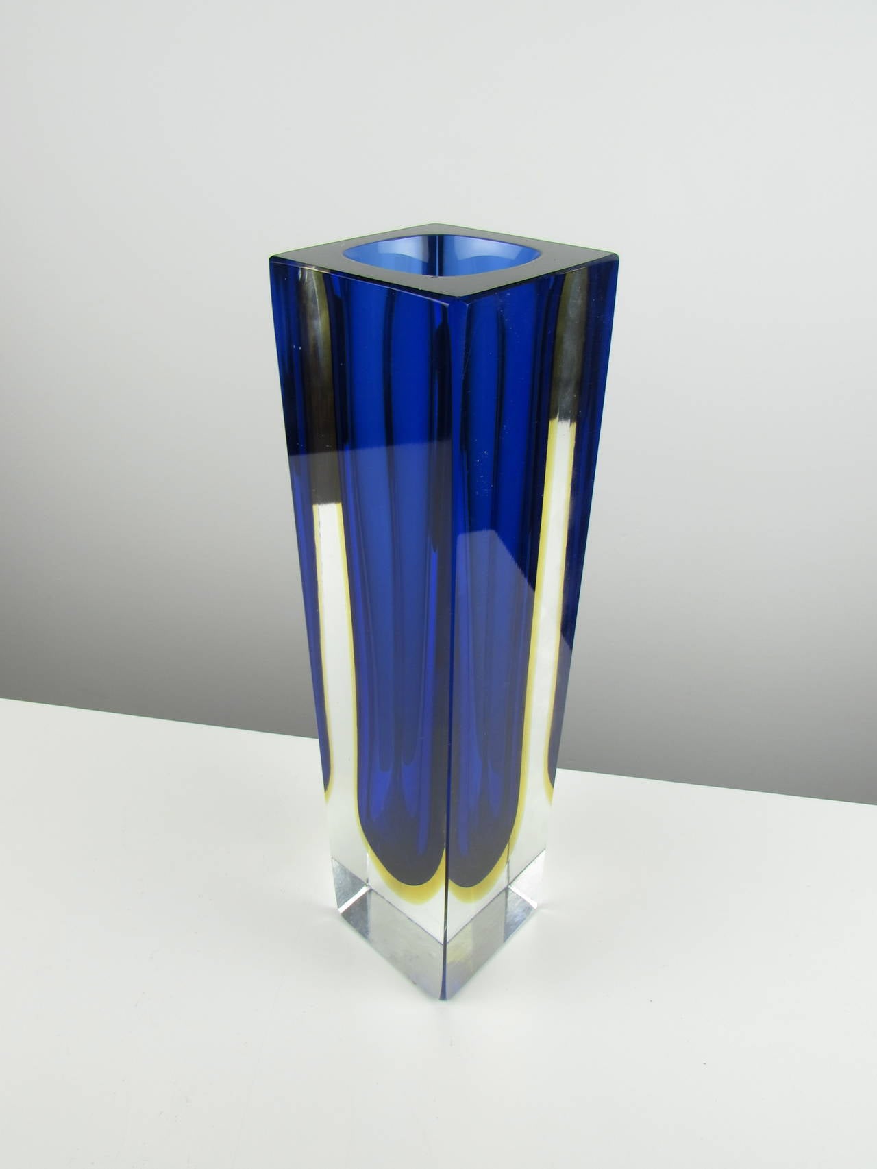 Massive rectangular Sommerso Murano vase with cobalt and yellow center. This example of Sommerso glass is one of the largest we have seen, standing at 12 inches tall. The colors are vibrant and mesmerizing. Condition is excellent.

We offer free