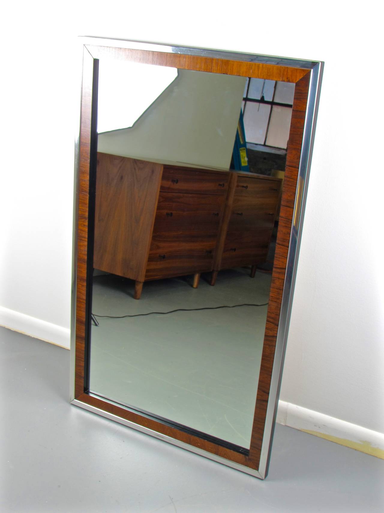 Large, striking Baughman style rosewood and chrome wall mirror by John Stuart, 1970s. Trimmed in chrome and rosewood with fantastic grain. Condition is excellent. 

We offer free regular deliveries to NYC and Philadelphia area. Delivery to DC, MD,