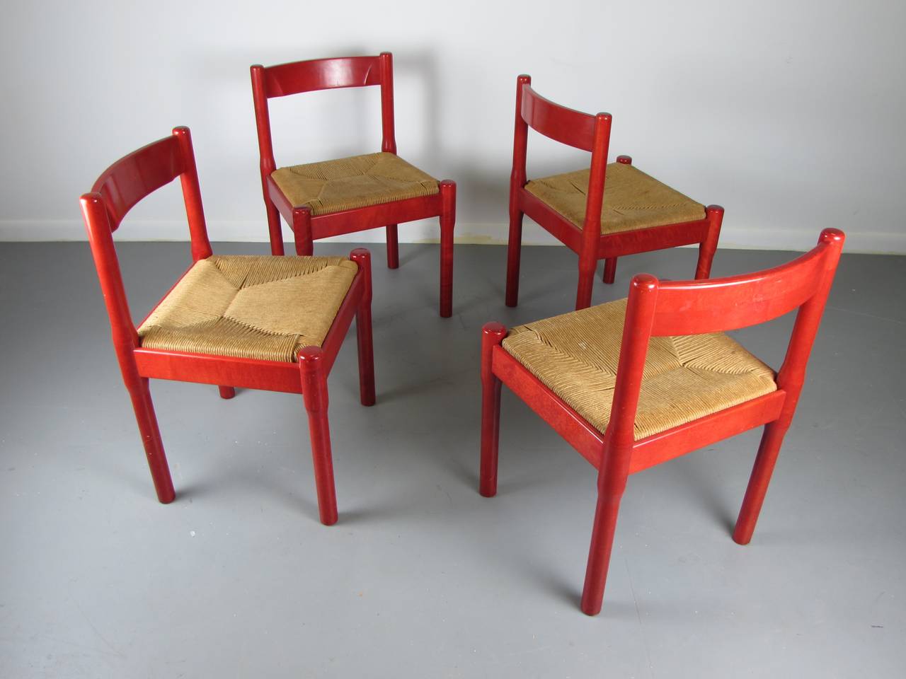 Rare set of red Carimate dining chairs by Vico Magistretti for Stendig, 1950s. These chairs are in excellent vintage condition. They appear to have seen very little use. The red stain finish is in excellent condition and rarely seen!

See this