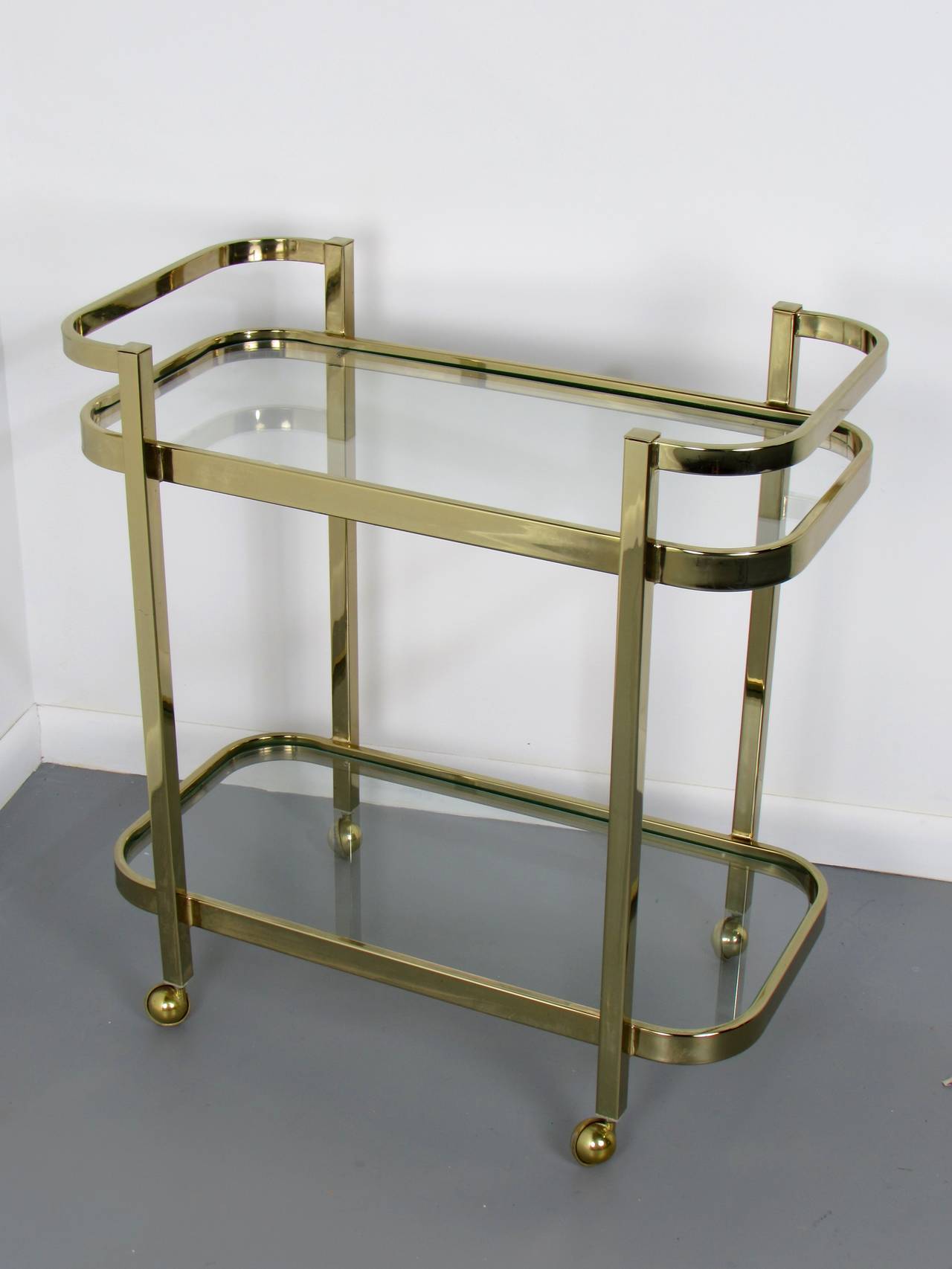 Luscious brass bar cart by Milo Baughman for Thayer Coggin, 1970s. This piece is in excellent condition with minor wear. 

We offer free regular deliveries to NYC and Philadelphia area. Delivery to DC, MD, CT and MA are available if schedule
