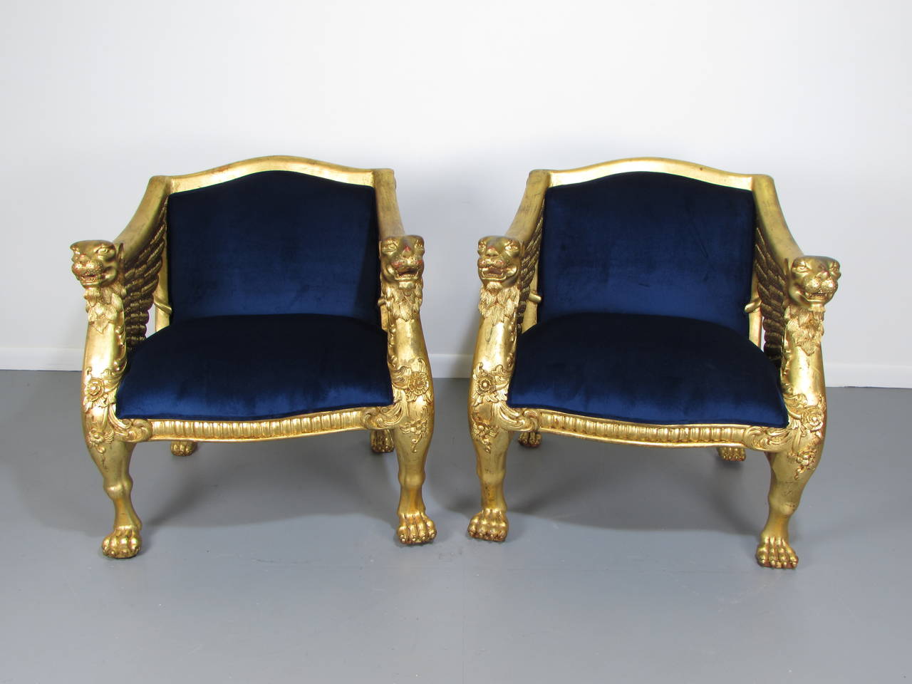 Extravagant 19th Century French Winged-Lion Giltwood Empire Throne Bergeres. Chairs were purchased in Paris in the 1950s at an antique market then privately imported to the US. Upholstery is new. The gilt wood frames have been left in vintage