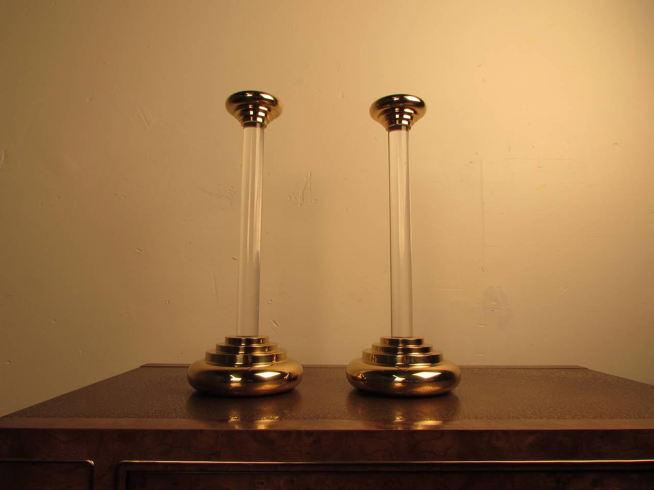 Large pair of brass and Lucite candlesticks in the manner of Karl Springer. In gorgeous condition with newly refinished brass.