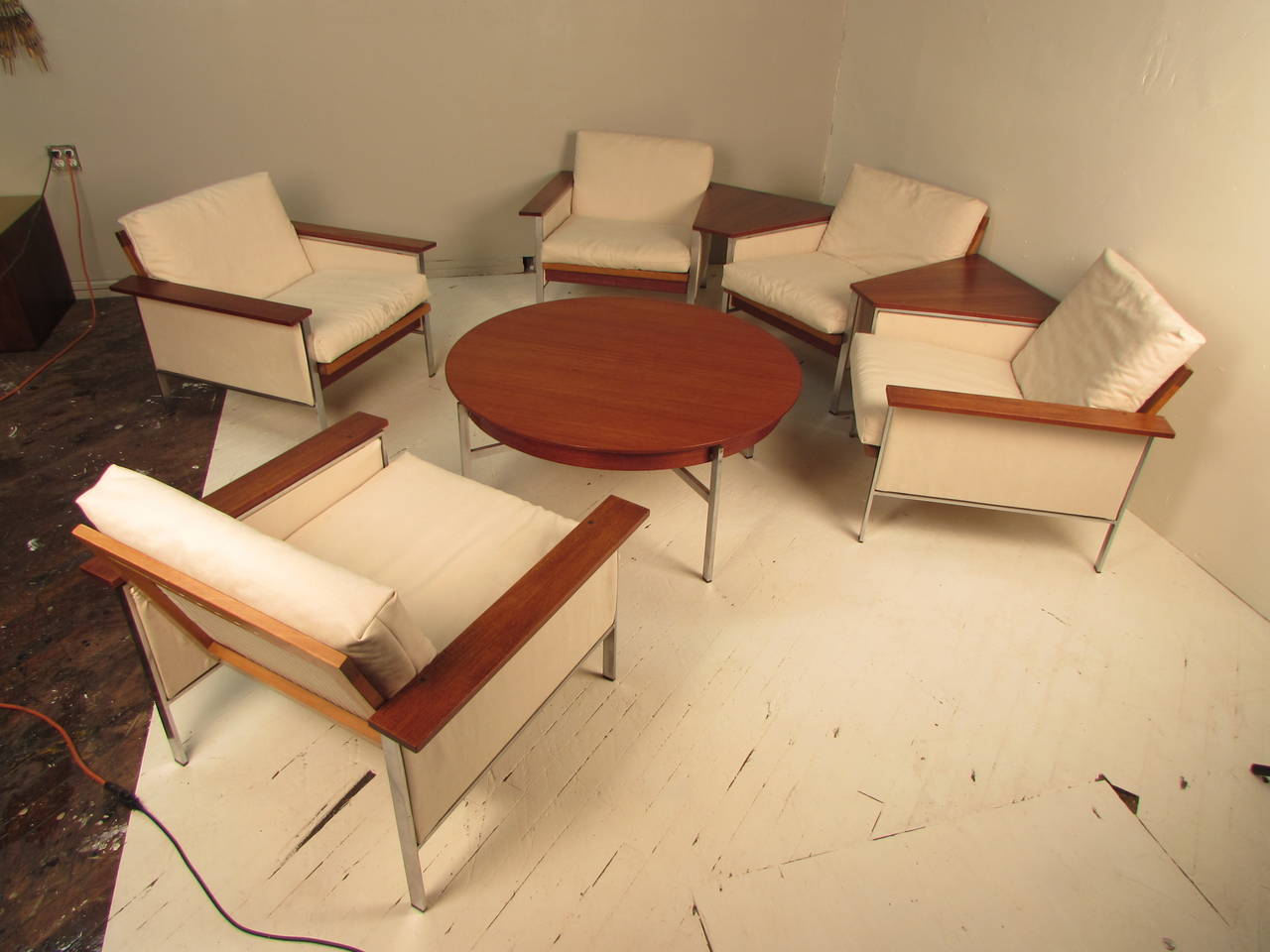 Gorgeous walnut and chrome, 1960s eight-piece living room suite by Mustering, Germany. The suite consists of five lounge chairs, two attached floating side tables, and a round cocktail table.
These pieces were purchased in Denmark and personally