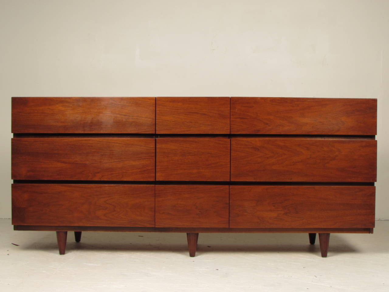 Handsome 9-drawer chest in walnut by American of Martinsville. Exceptional case piece that would work well with nearly any style of interior design. Well crafted and substantial. In excellent vintage condition with gorgeous, glowing original finish.