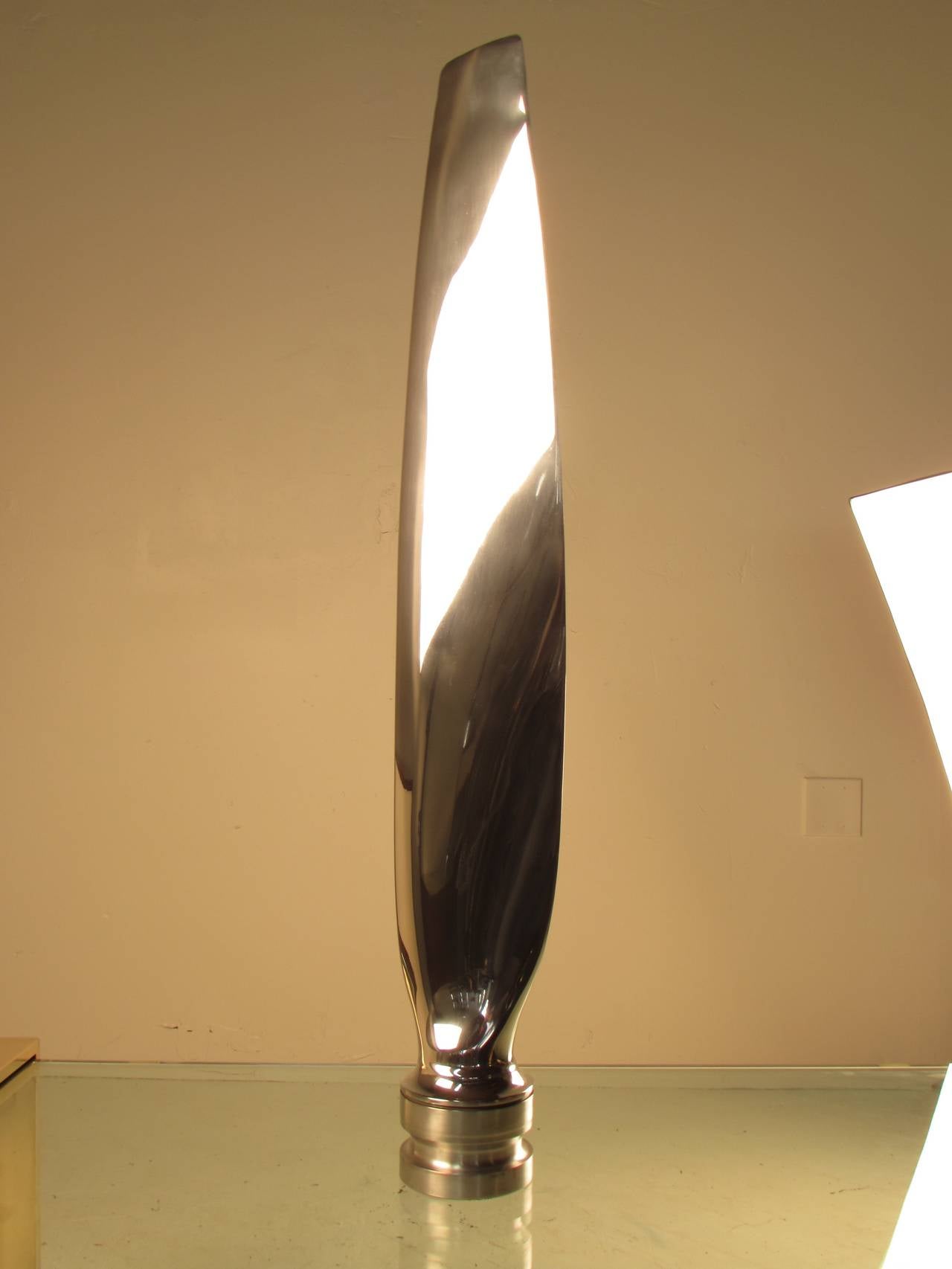 Machine Age freestanding cast aluminum military plane propeller blade on a steel base. We have just had this piece highly mirror polished and the result is utterly spectacular! Intriguing piece of Industrial sculpture.