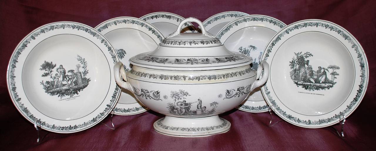 Creil creamware lidded soup tureen with Cupid scenes.  Assembled soups with Cupid and other classical subjects. All with grape leaf border. Tureen with swans and grape leaf borders. 

All  Stamped Creil, soups with additional marks for Legros
