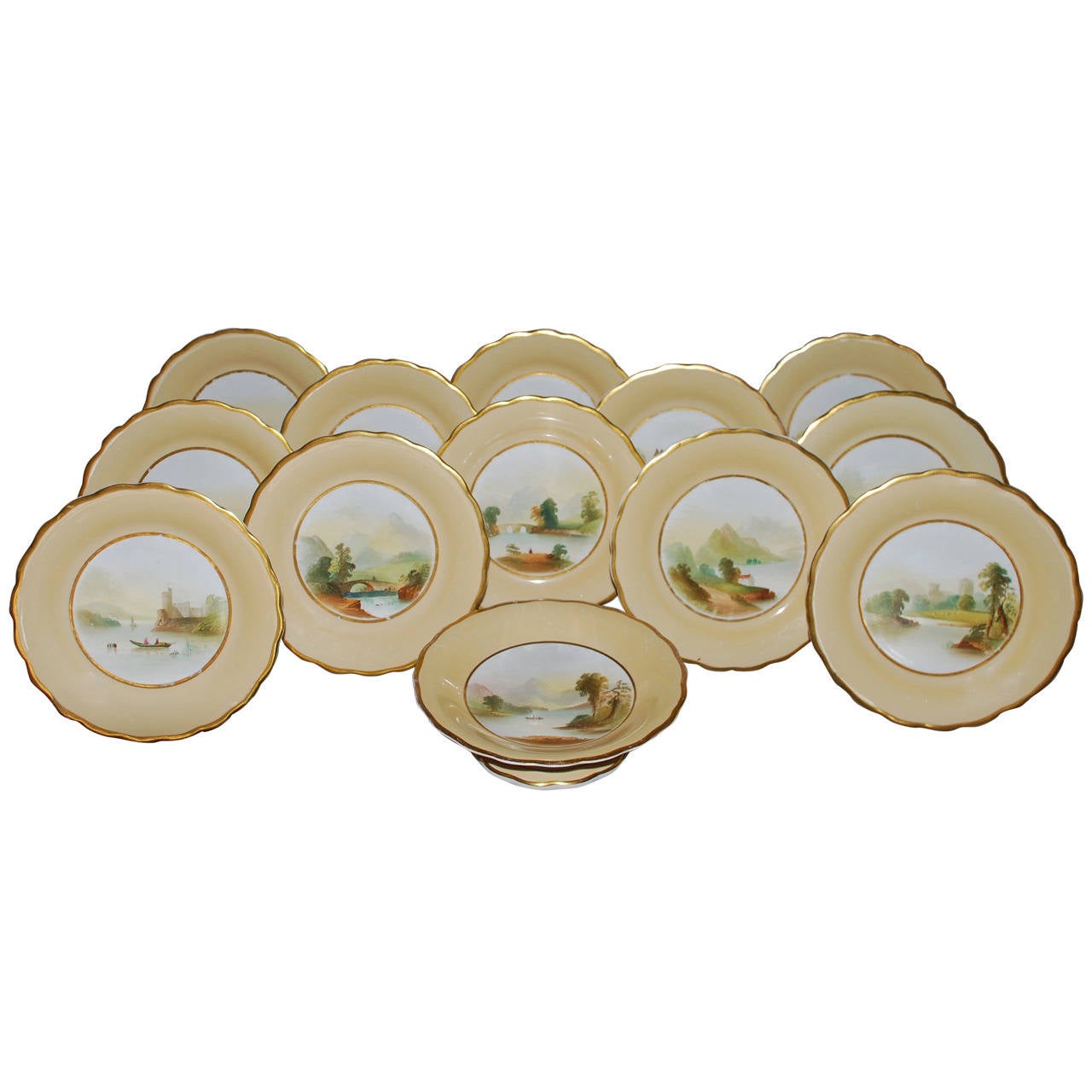 Set of 12 gilt-rimmed dessert plates and cake stand with Scottish scenes. The scalloped-edge and gilt plates with stand feature hand-painted Scottish scenes with various famous castles and their locations on reverse; perfect for a Burns Night