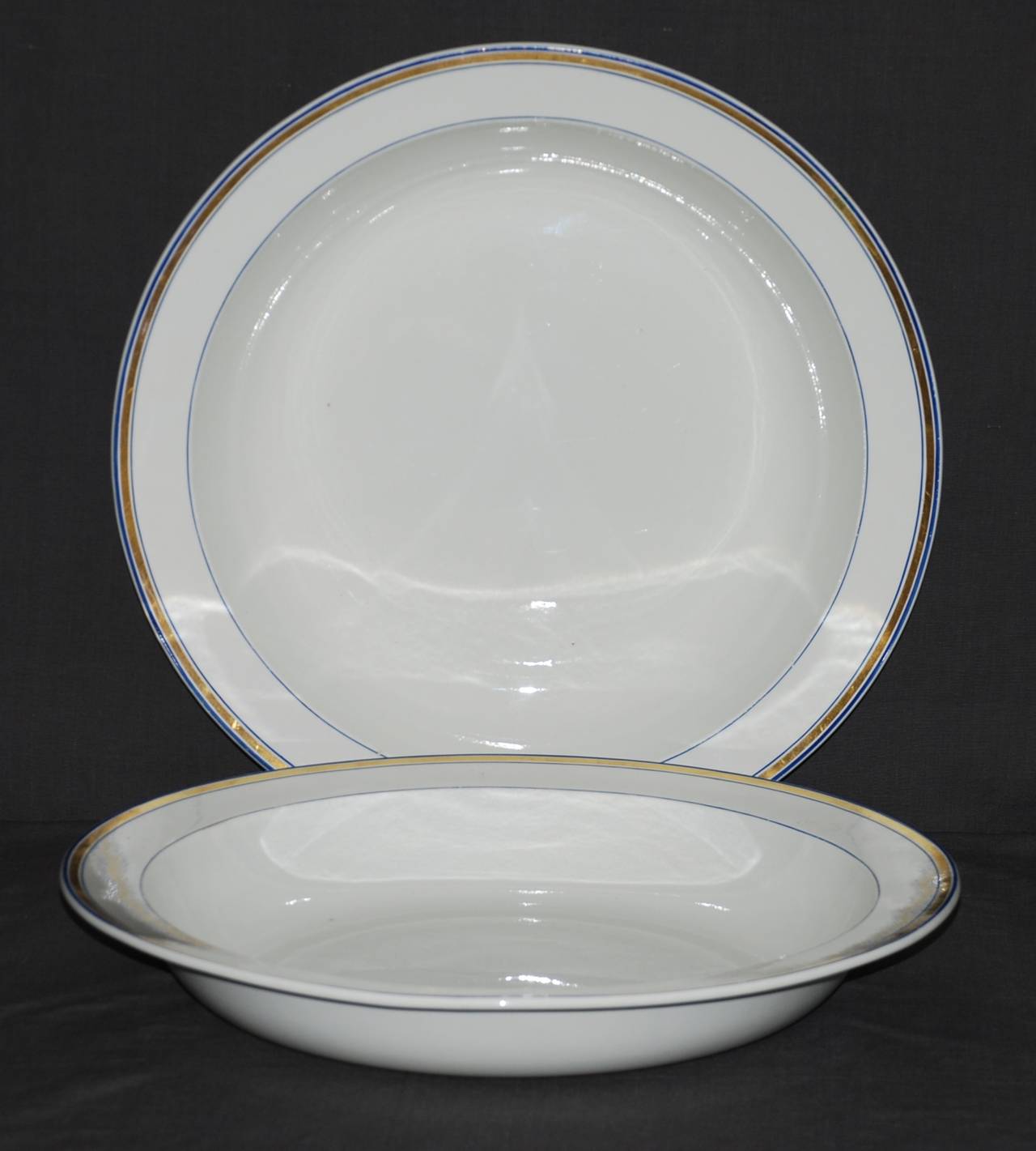 Pair large Wedgwood creamware serving plates. Pair Wedgwood creamware serving plates with blue band and gilt rim. Impressed mark 