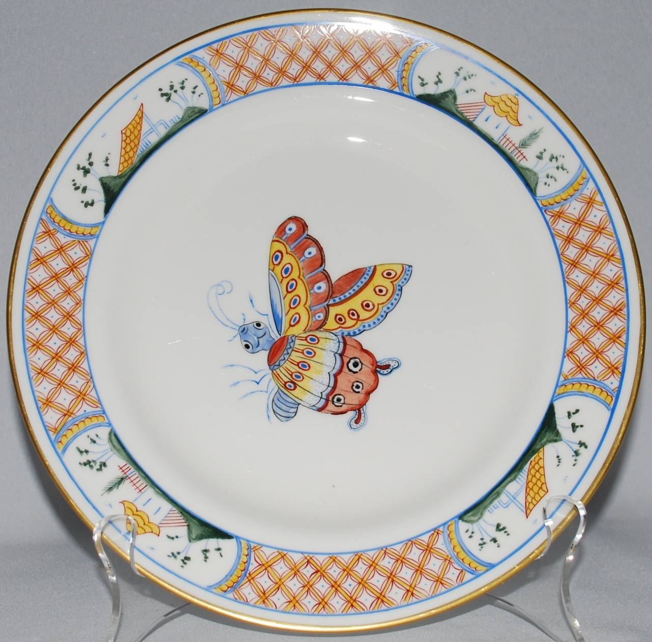 Set of six vintage Tiffany & Co. private stock gilt-rimmed chinoiserie dinner plates hand-painted in France with butterflies. 
Diameter 9.25