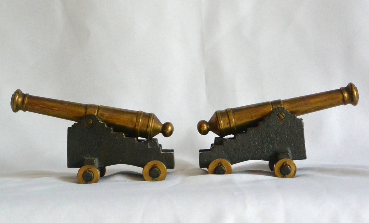 Pair vintage model American brass plated cannons on iron carriages. Stamped 