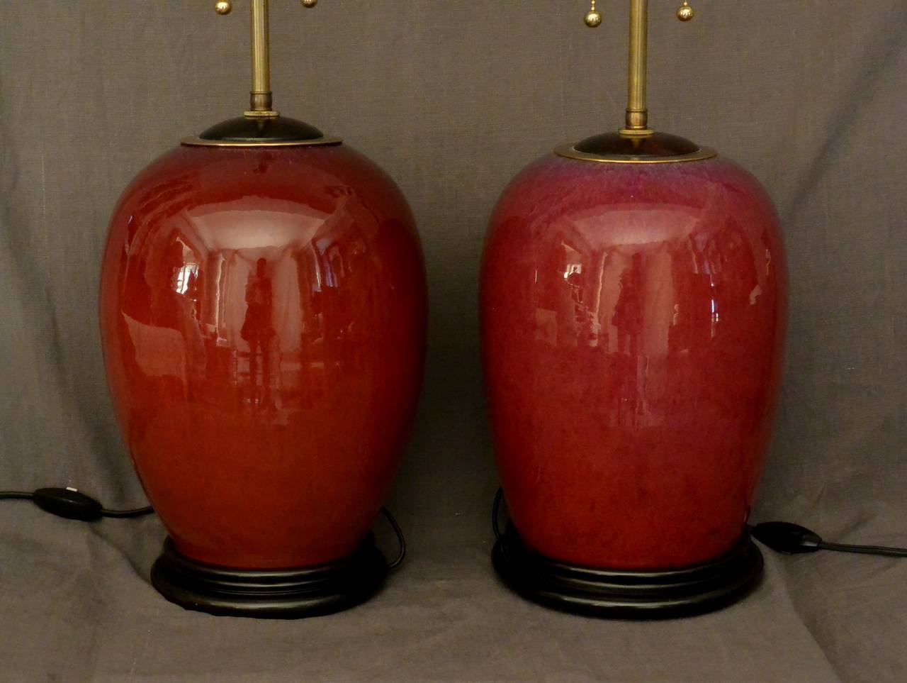 Near pair of flambe Sang de Boeuf lamps of ginger jar form on wood base. China, early 19th century. Newly electrified with black silk cord and switch.
Dimension:
Lamp 1: 8
