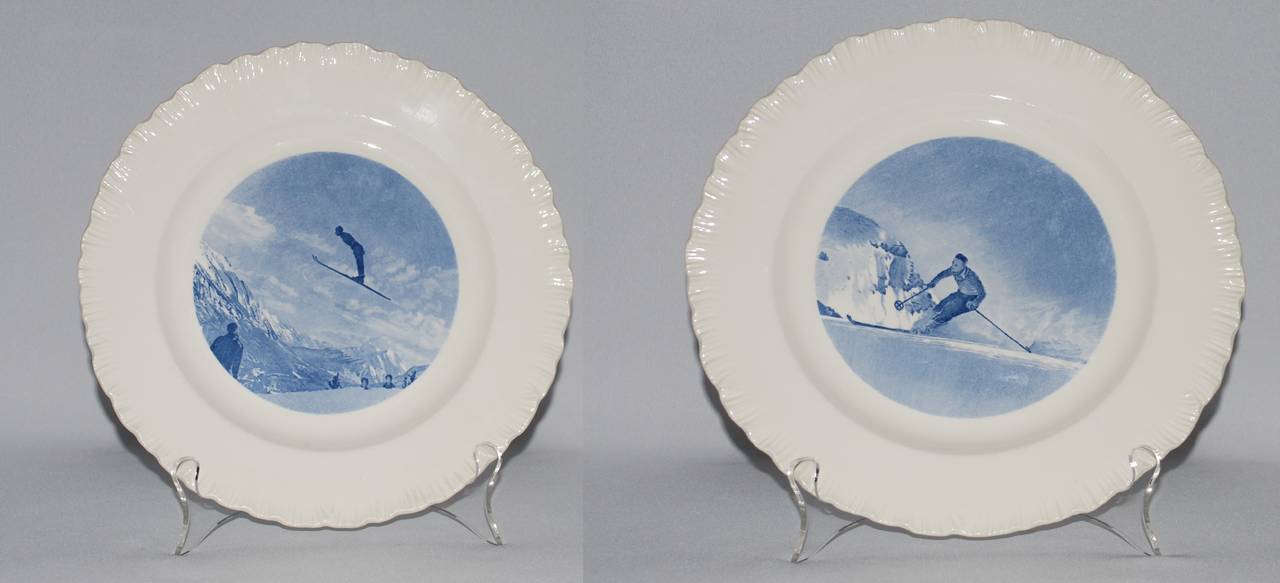 Twelve Wedgwood blue and white feather edged plates with Canadian ski resort scenes. Stamped 1946. Diameter 9.5