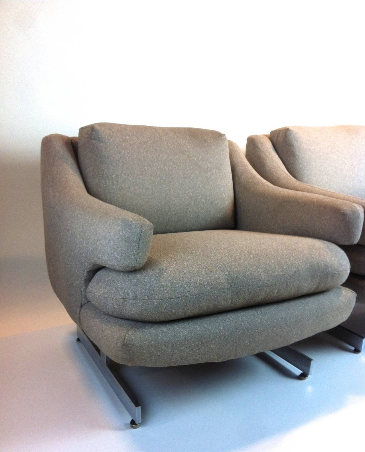 This handsome pair floats on a chrome base, offering comfort and style without the weight.  Designed in the 1970s by Milo Baughman.  They are good candidates for reupholstering and this is reflected in the pricing. C.O.M. services available.