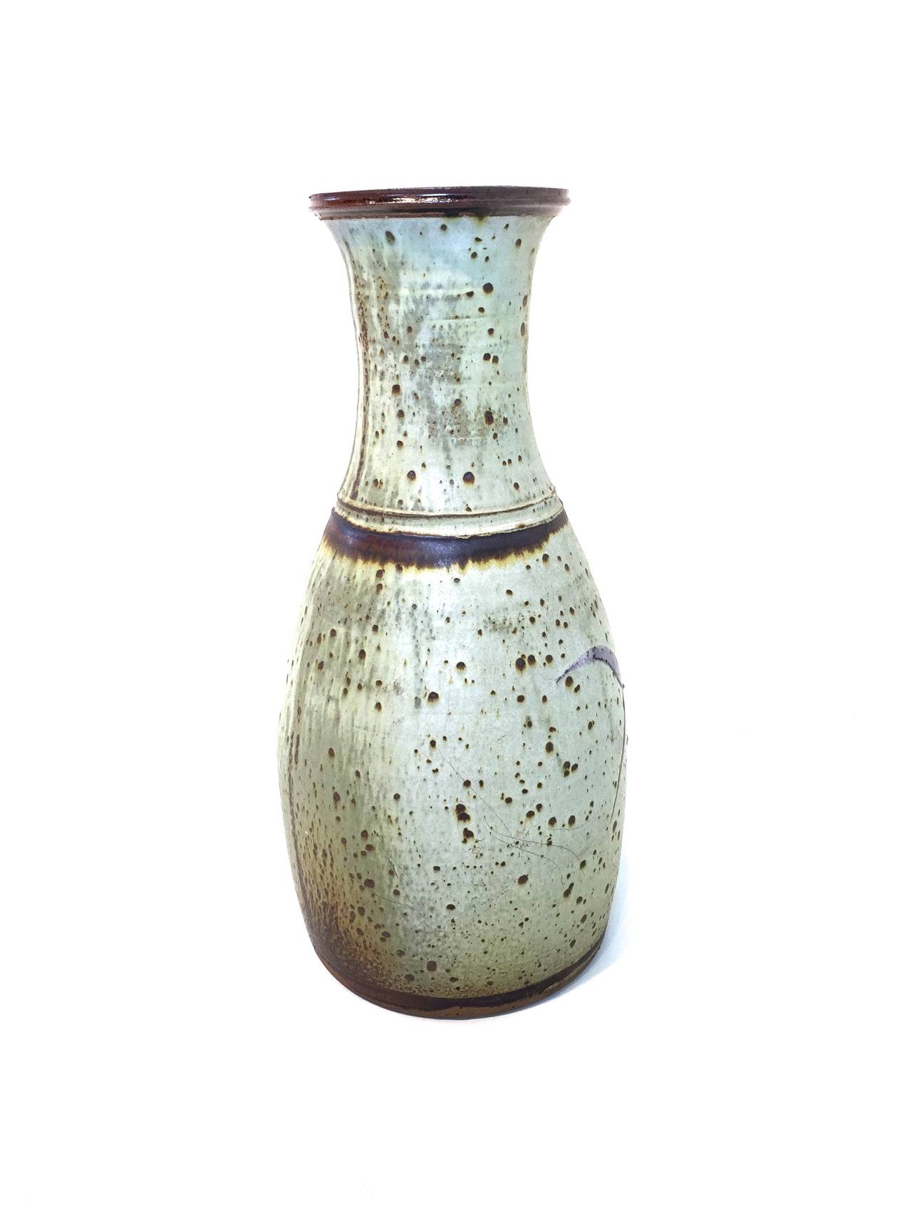This spectacular hand-thrown pot closely shares the calligraphic style of Creitz's smaller pieces, but it is unsigned. It has a glossy interior glaze, while the outside is matte with brushwork. Creitz was a student of Ray Grimm at Portland State