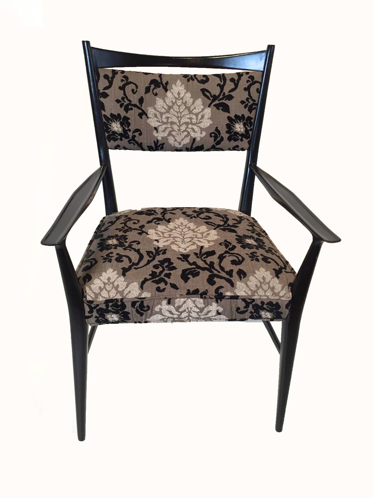 Pair of ebony lacquered Paul McCobb Armchairs for the Calvin Furniture Group. Upholstered in recent floral black and white tapestry.