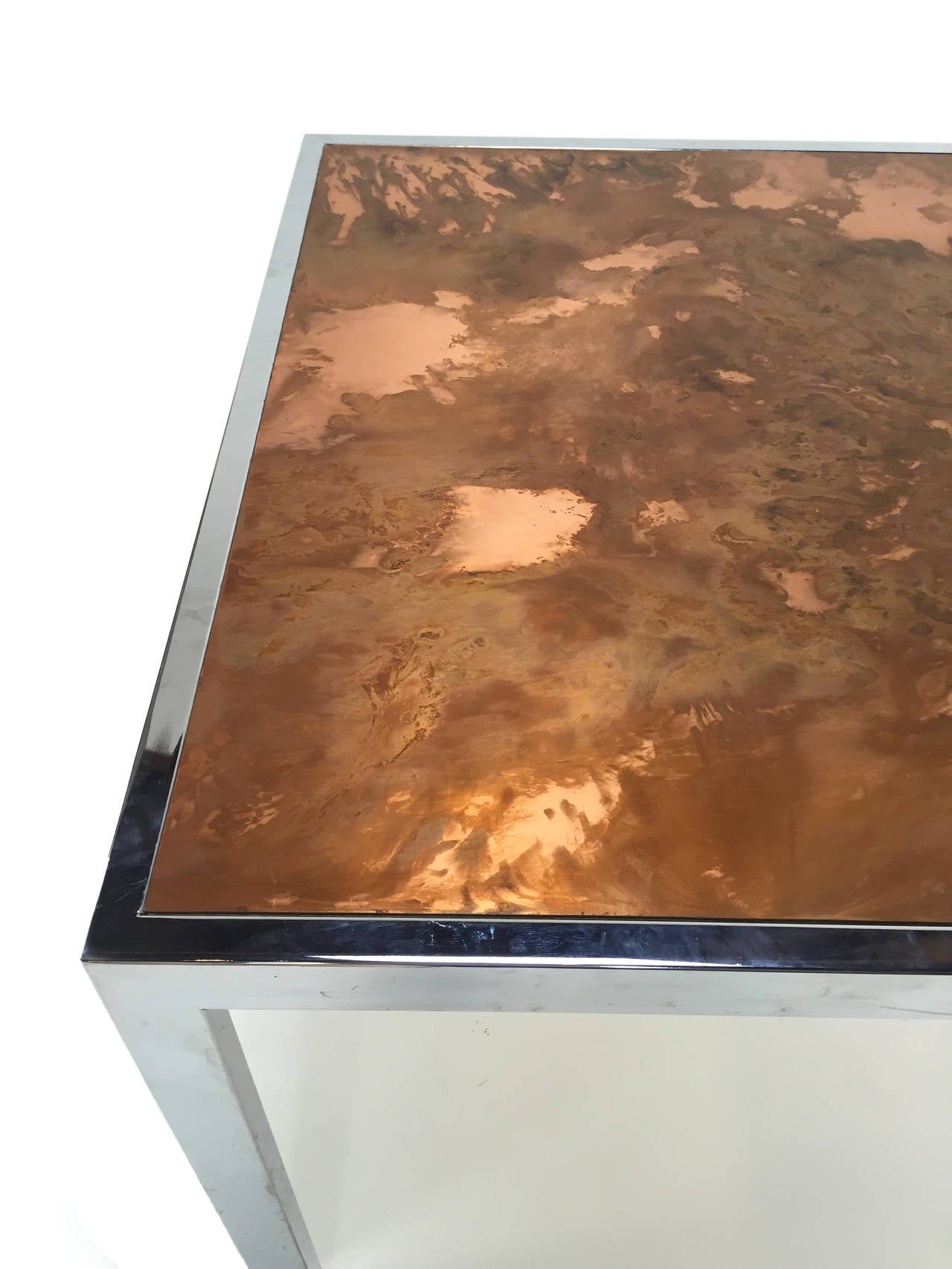 Table top surface of acid washed copper. Widely cherished Baughman signature architectural chrome rectangular stock frame. The inset top of chemically treated copper feels as if its exploding with fire and drama yet remains contained within the