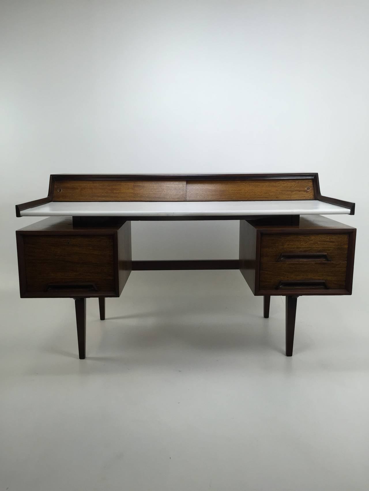 Cantilevered desk by Milo Baughman for the Perspective Line by Drexel ca 1952. Mahogany surfaces over solid core. Laquered desk writing surface.