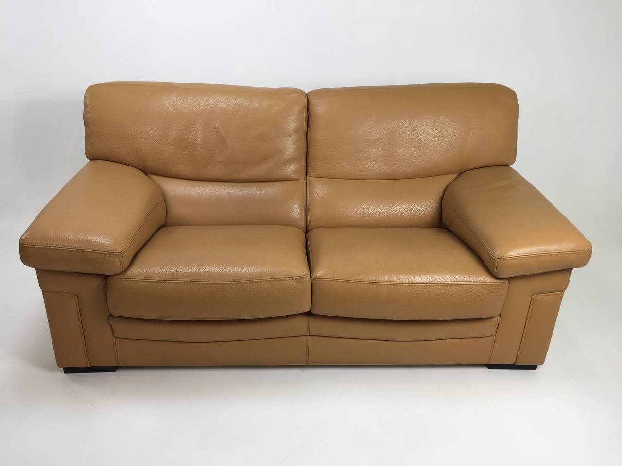 Butter soft 3mm thick full grain caramel leather make this pair of Roche Bobois sofas designed by Hans Hopfer a lux option.