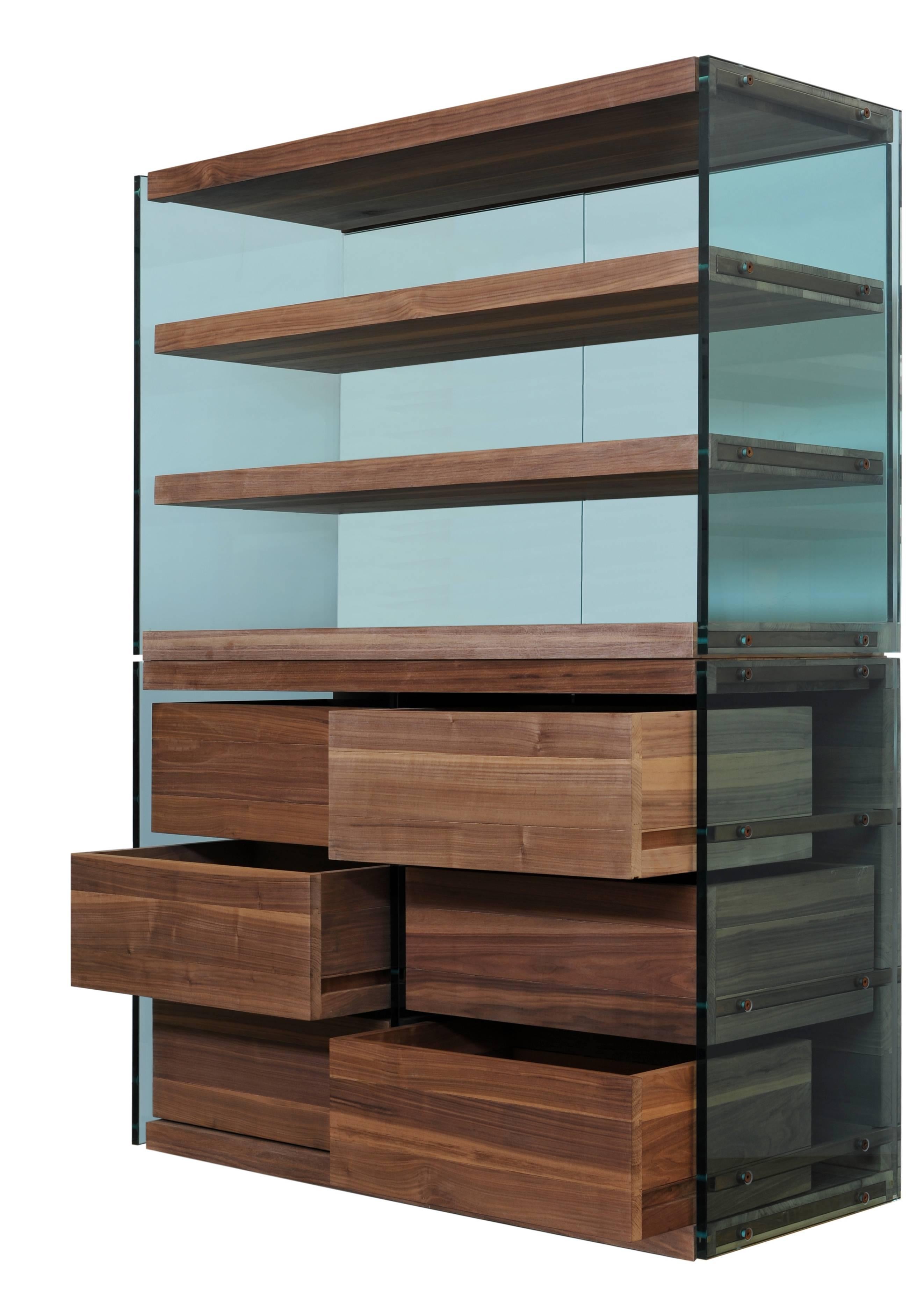 This armoire is constructed of Italian steel, walnut and glass. Its side panels are made of glass, the back panel made of glass and black walnut, and drawers constructed of only black walnut, with all solid wood fixed with natural glue. The metallic