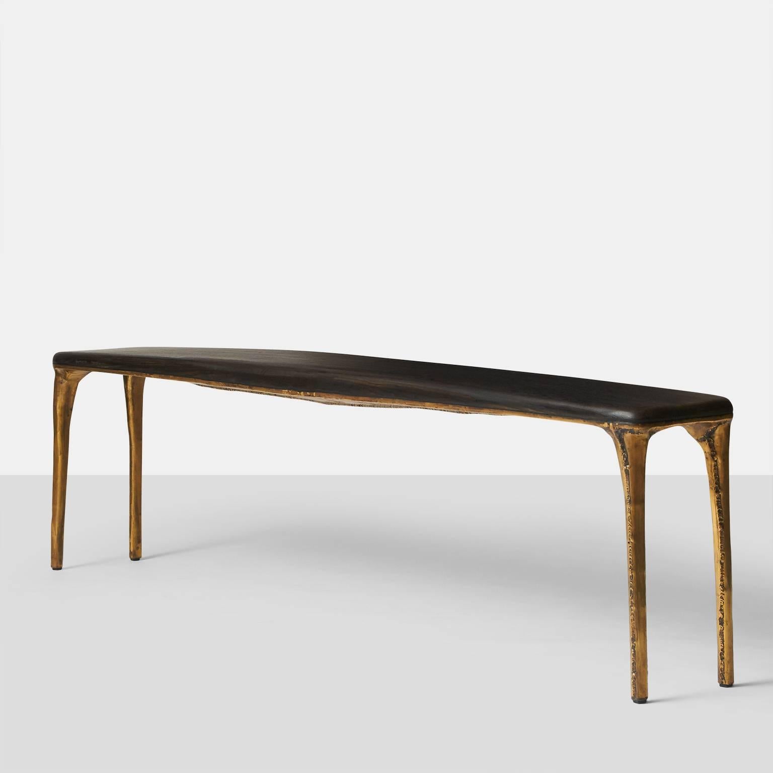 A long bench by German furniture designer Valentin Loellmann, circa 2016. Completely hand constructed in brass and not cast, with a charred oak seat that has been made to fit the shape. The brass construction creates a unique pattern on each piece.
