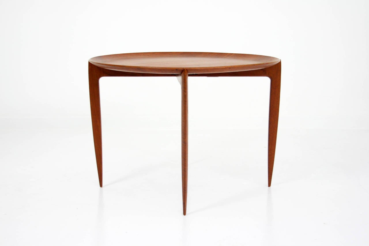Circular Teak Tray table by Engholm & Willumsen for Fritz Hansen. Teak tray is lipped and sits upon a collapsible ebonized stand for easy storage.