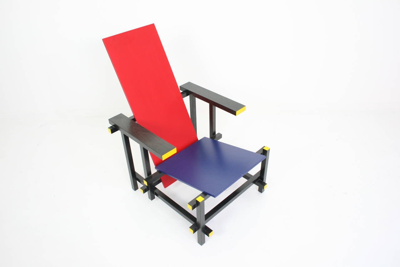 Classic chair designed by Gerrit Thomas Rietveld for Cassina consisting of a colored seat and back which are supported by a visually minimal black frame. This chair really embodies the de Stijl movement, with it's primary colors and weightless,